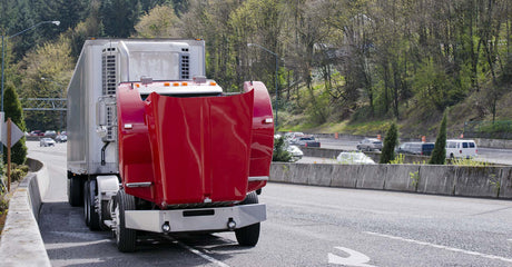 Semi truck with hood up being worked on